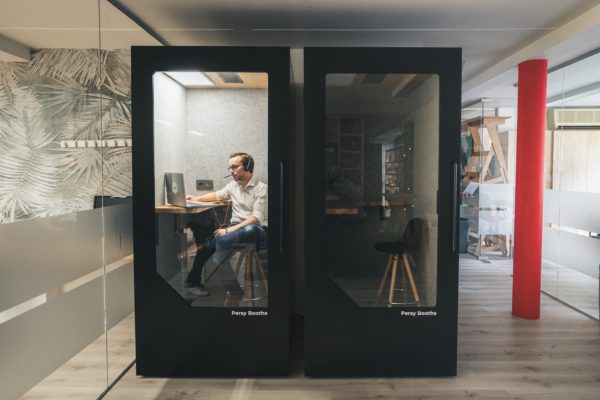 Digital Marketer working at phone booth.